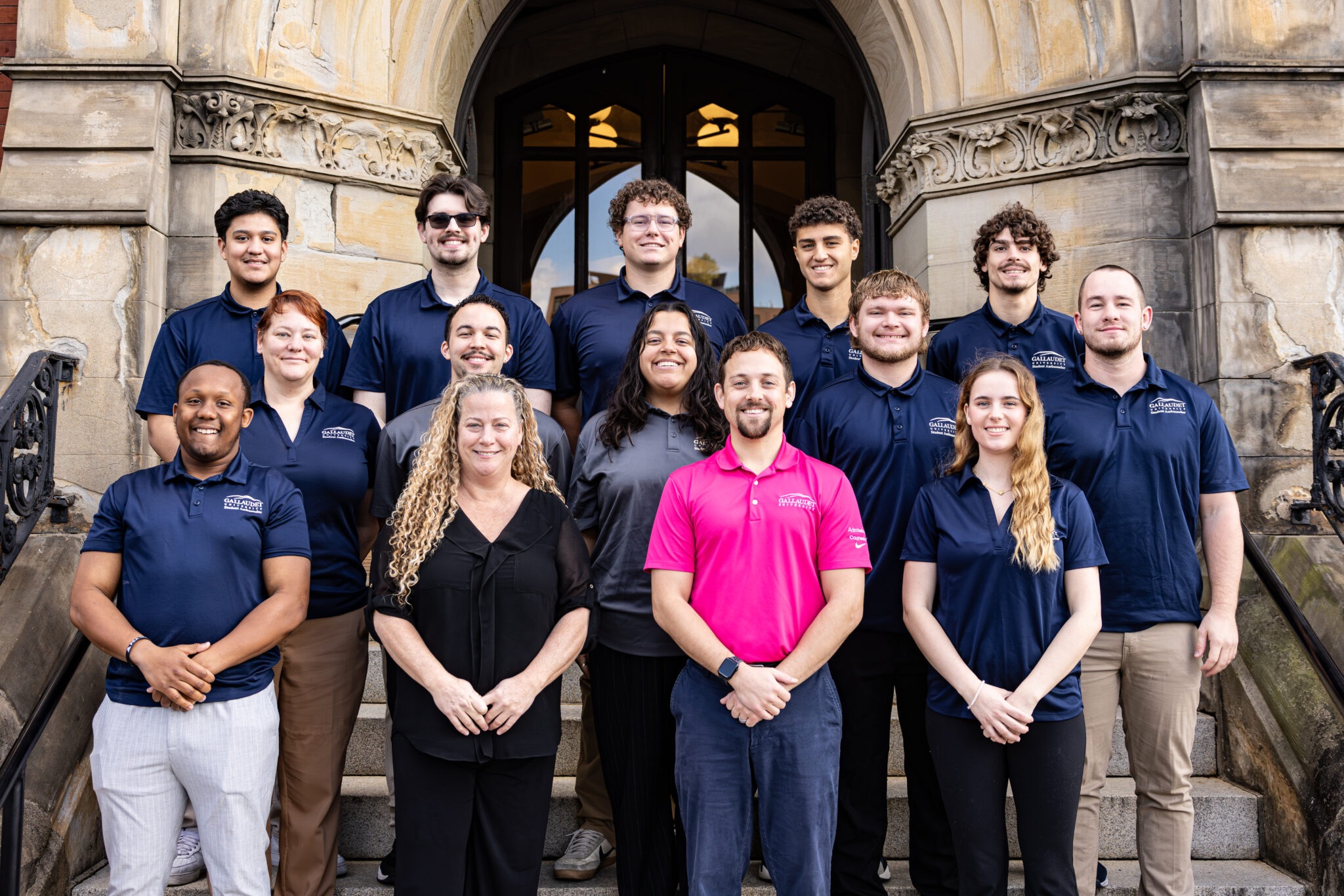 Group of student ambassadors and Admissions staff stand together, smiling